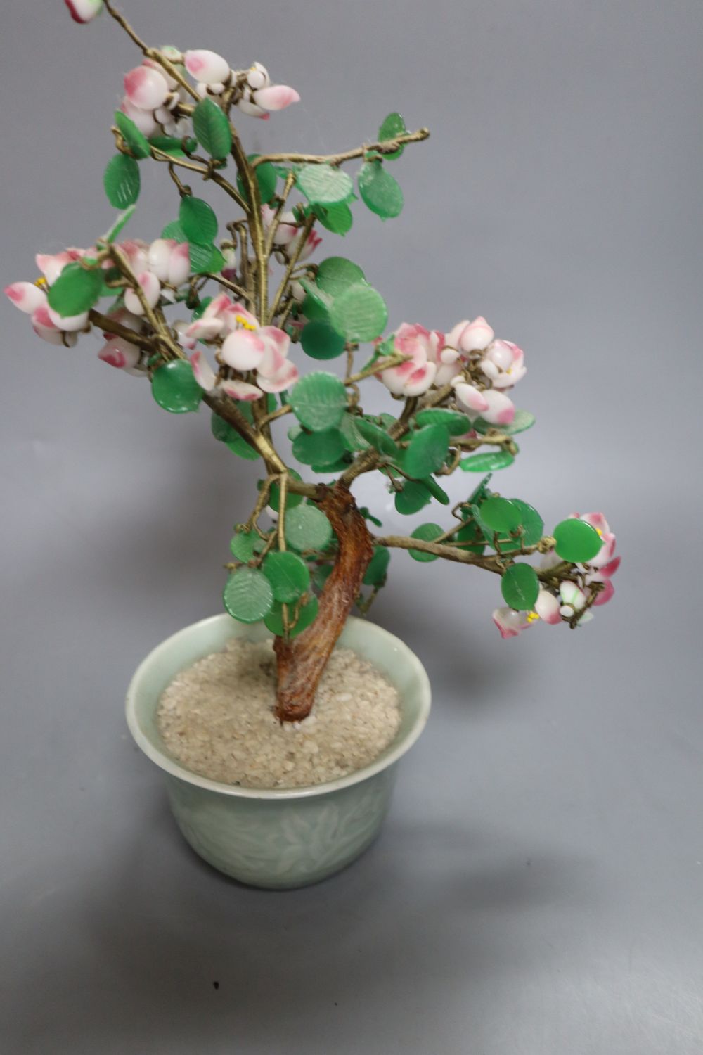 A Chinese agate vase and cover and a hardstone tree, in carved celadon jardiniere, 29cm